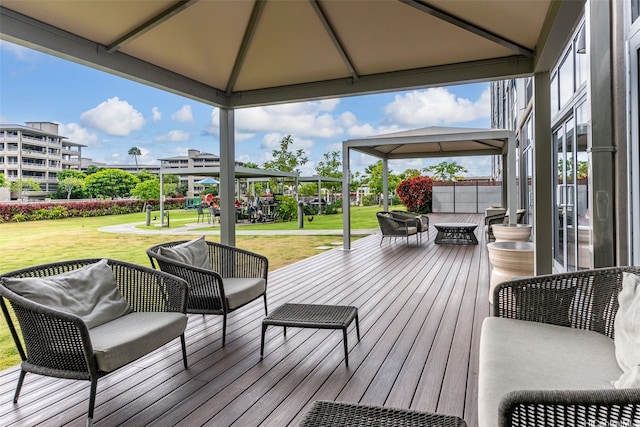 wooden deck with an outdoor hangout area, a lawn, and a playground