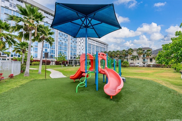 community playground featuring fence and a lawn