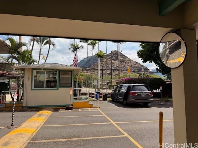 uncovered parking lot featuring a mountain view