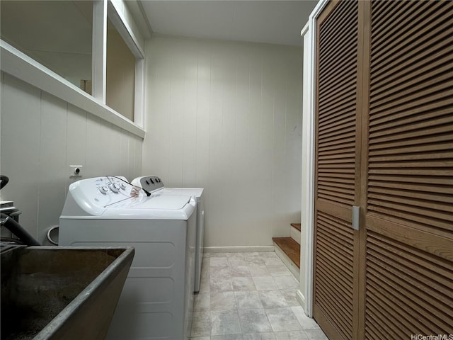 laundry room featuring a sink, independent washer and dryer, a heating unit, laundry area, and wooden walls