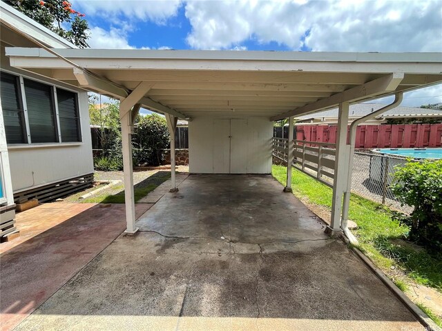 view of parking / parking lot with fence