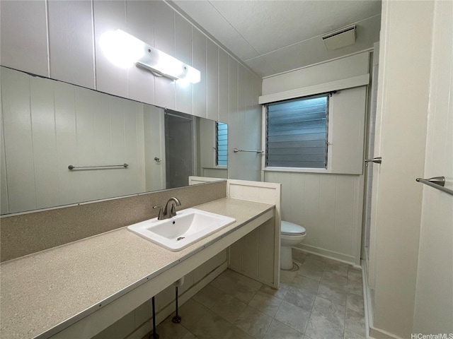 bathroom featuring visible vents, toilet, and vanity