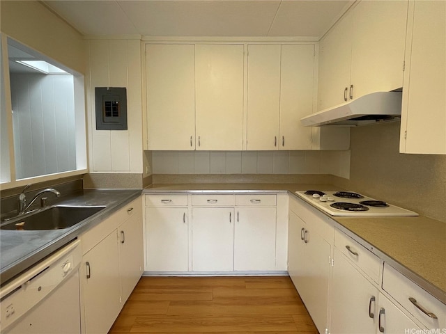 kitchen featuring white appliances, under cabinet range hood, electric panel, light wood finished floors, and a sink