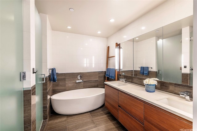 1108 Auahi St Unit 1001, Honolulu, HI 96814 - bathroom featuring double vanity, a freestanding tub, tile walls, and a sink