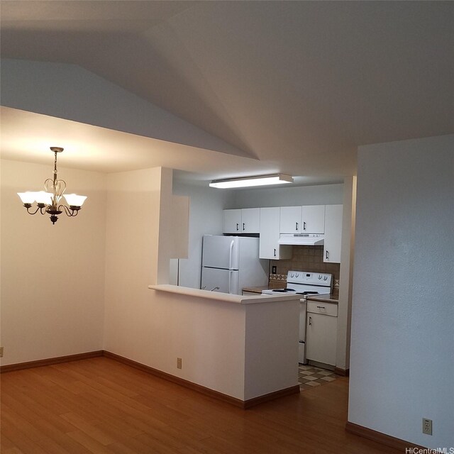 95-660 Wikao St Unit K206, Mililani, HI 96789 - kitchen featuring white cabinets, under cabinet range hood, an inviting chandelier, dark wood-type flooring, and white appliances