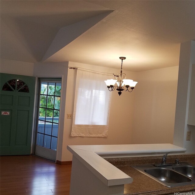 95-660 Wikao St Unit K206, Mililani, HI 96789 - interior space featuring dark wood finished floors, a chandelier, decorative light fixtures, a sink, and baseboards