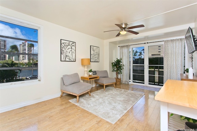 445 Kaiolu St Unit 211, Honolulu, HI 96815 - living area featuring wood finished floors, ceiling fan, baseboards, and a city view