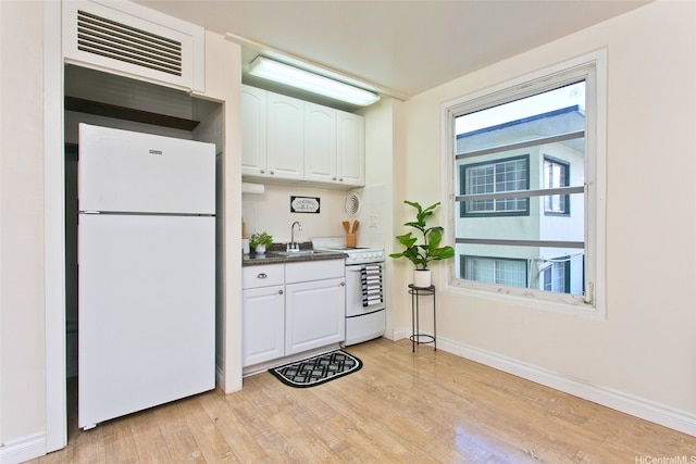 445 Kaiolu St Unit 211, Honolulu, HI 96815 - kitchen with white appliances, a sink, light wood finished floors, and white cabinets