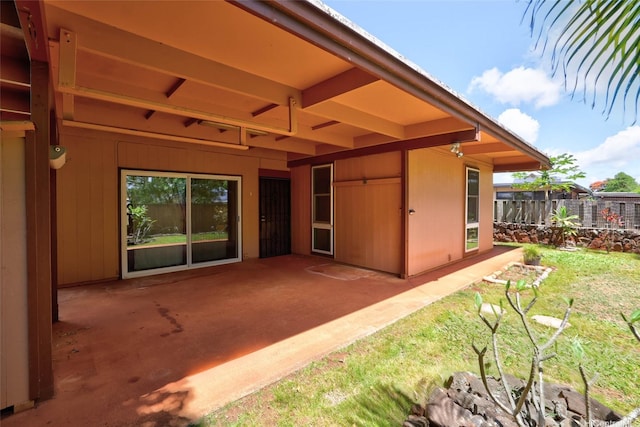 back of house featuring a lawn, fence, and a patio