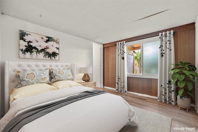 bedroom featuring baseboards and wood finished floors