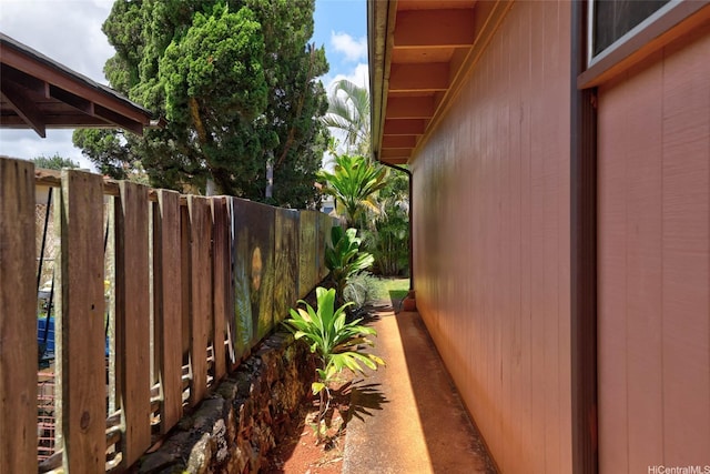 view of side of home featuring fence