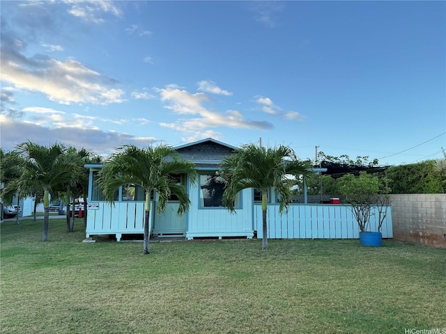 exterior space with fence and a front yard