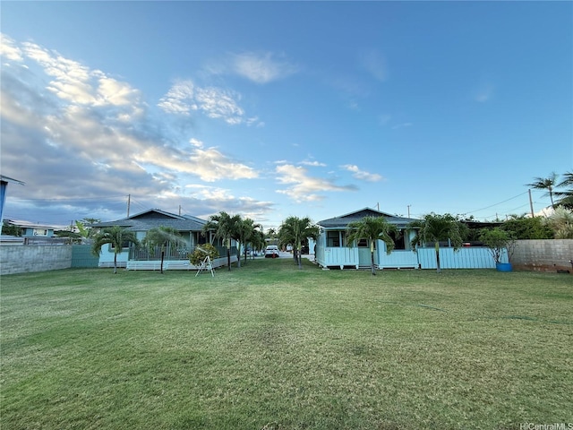 view of yard featuring a sunroom and fence