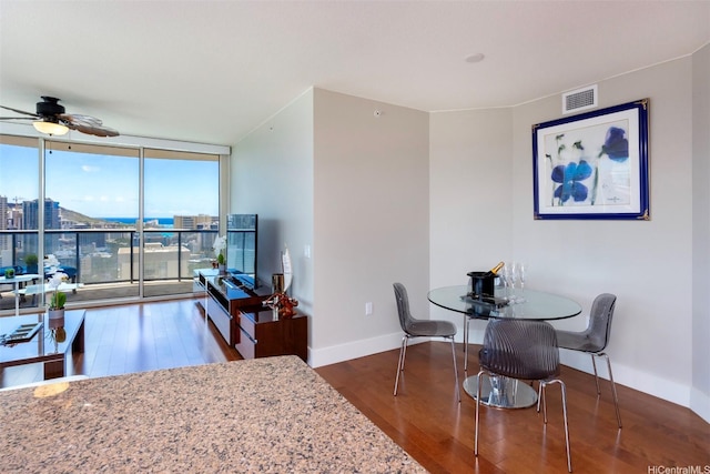 1837 Kalakaua Ave Unit 3304, Honolulu, HI 96815 - dining area featuring floor to ceiling windows, ceiling fan, wood finished floors, and baseboards