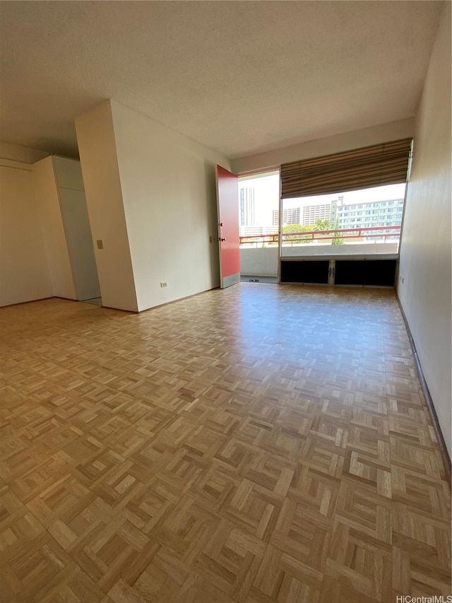 1670 Kalakaua Ave Unit 401, Honolulu, HI 96826 - unfurnished bedroom featuring baseboards and a textured ceiling