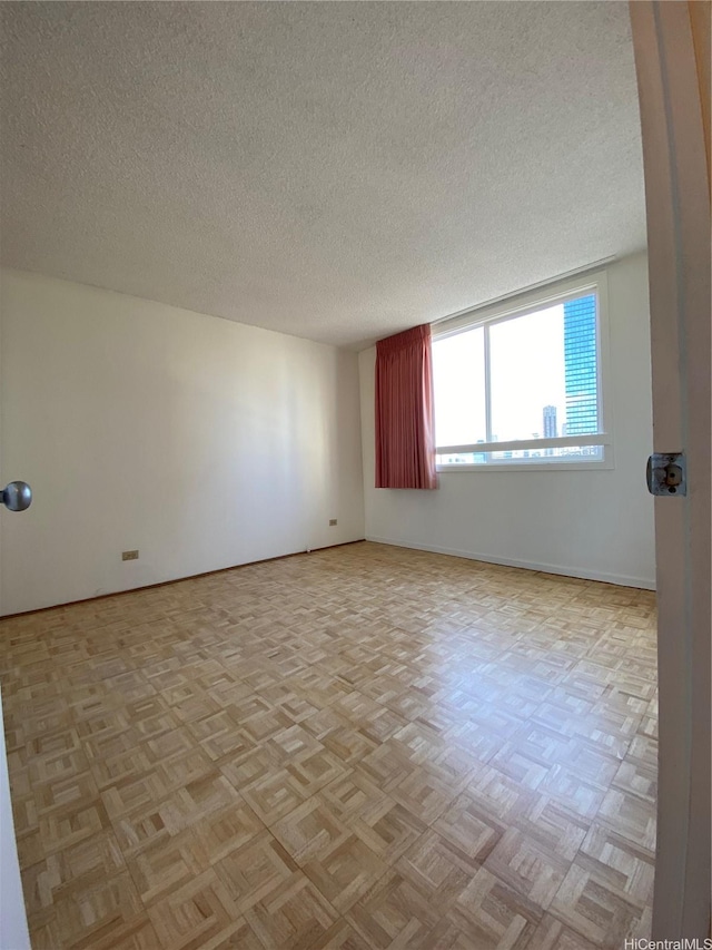 1670 Kalakaua Ave Unit 401, Honolulu, HI 96826 - unfurnished room with baseboards and a textured ceiling