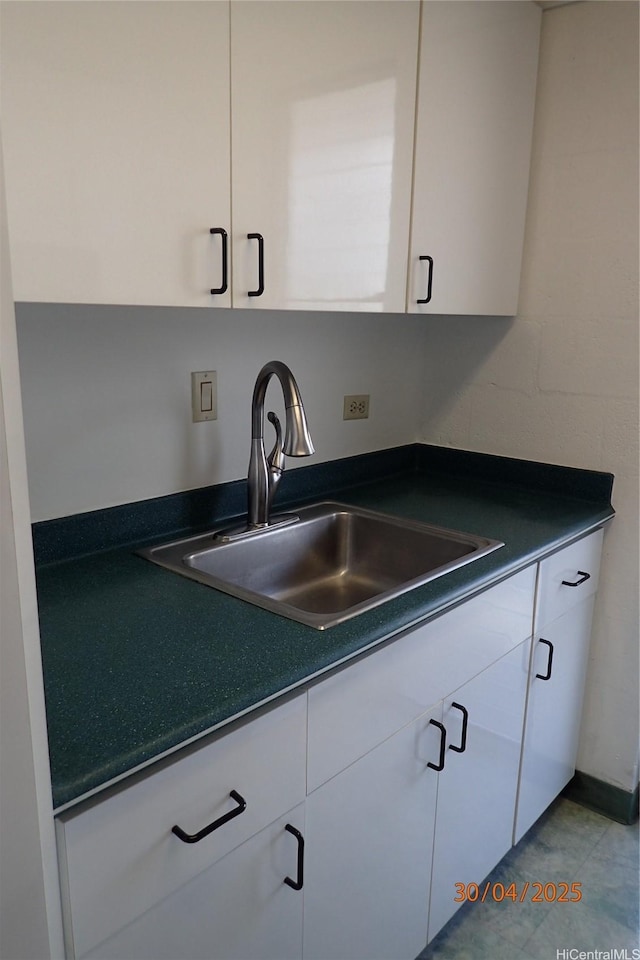 1670 Kalakaua Ave Unit 401, Honolulu, HI 96826 - kitchen featuring a sink, dark countertops, and white cabinets
