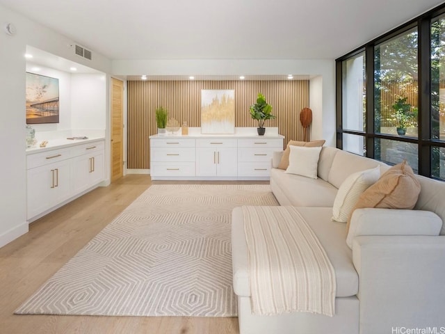 1525 Wilder Ave Unit 502, Honolulu, HI 96822 - living area with light wood finished floors, recessed lighting, and a wall of windows