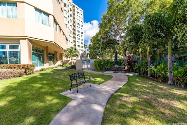 surrounding community featuring a gate, a lawn, and fence