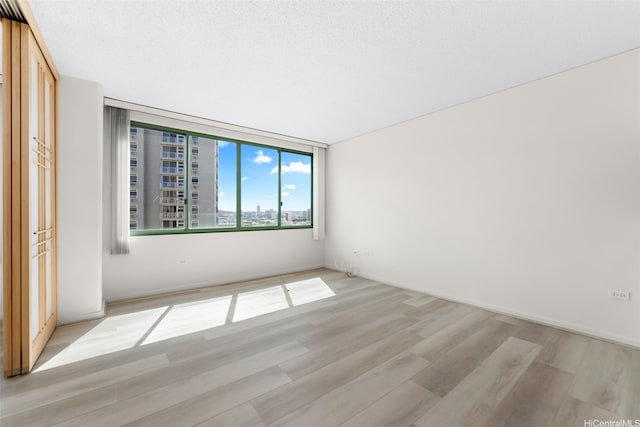 unfurnished bedroom featuring light wood-style floors
