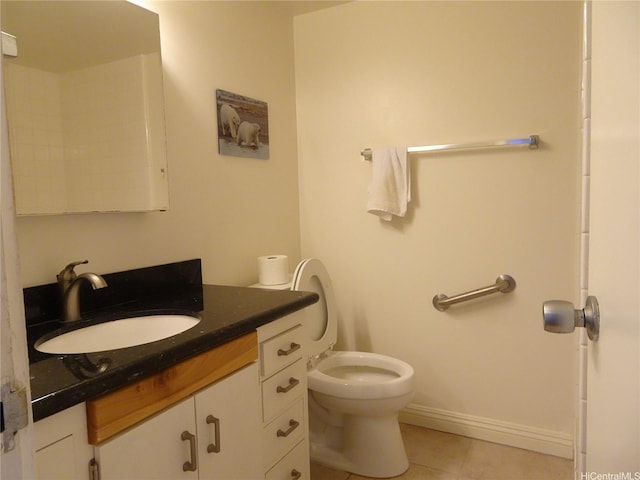 bathroom featuring tile patterned flooring, vanity, and toilet