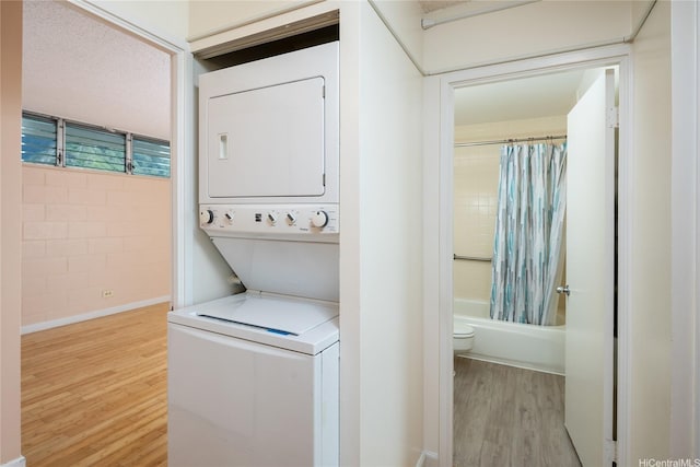 46-255 Kahuhipa St Unit A1204, Kaneohe, HI 96744 - washroom with stacked washer / drying machine, wood finished floors, and laundry area