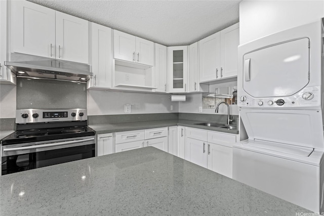 98-685 Kaonohi St Unit E, Aiea, HI 96701 - kitchen with electric range, stacked washer / dryer, a sink, under cabinet range hood, and white cabinets