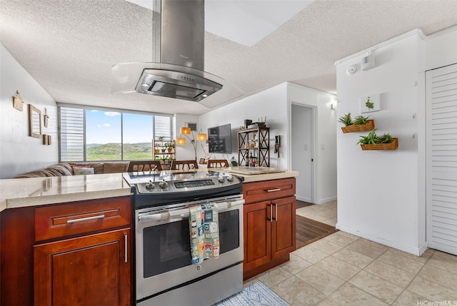 kitchen with electric range, a textured ceiling, light countertops, and island exhaust hood