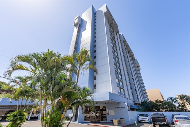 view of building exterior featuring uncovered parking