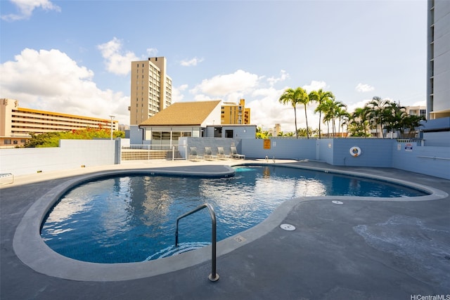 community pool featuring fence and a patio area