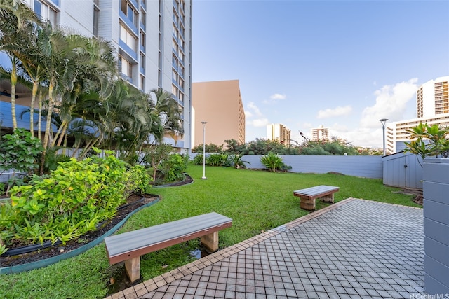 view of property's community with a yard and a patio