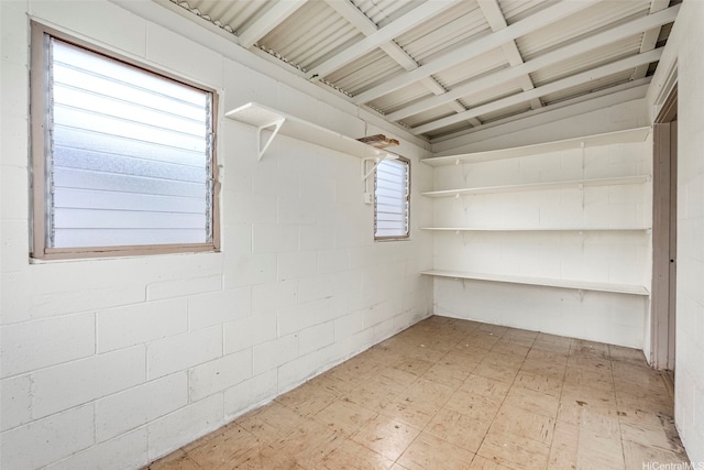 interior space with light floors and concrete block wall