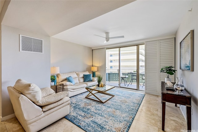 living room featuring light tile patterned floors, a ceiling fan, and visible vents