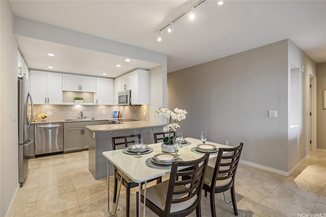 dining area featuring baseboards and recessed lighting