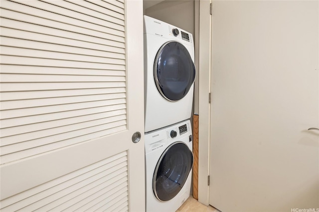 clothes washing area featuring stacked washer / drying machine and laundry area