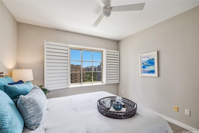 carpeted bedroom with baseboards and a ceiling fan