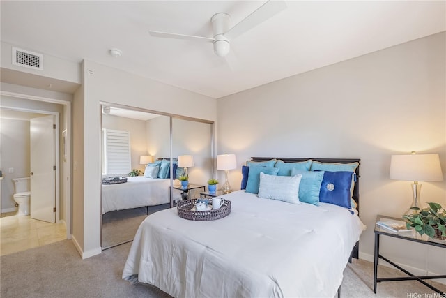 bedroom featuring light colored carpet, baseboards, visible vents, and a closet