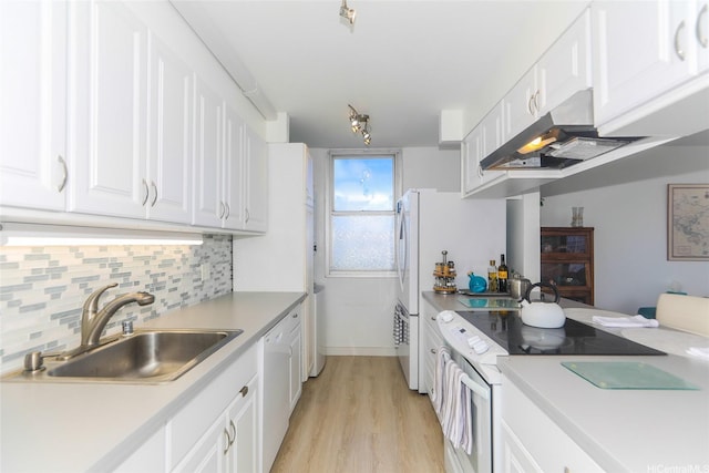 2600 Pualani Way Unit 1201, Honolulu, HI 96815 - kitchen with white appliances, under cabinet range hood, white cabinets, light wood-style flooring, and tasteful backsplash