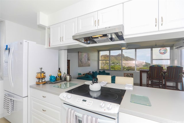 2600 Pualani Way Unit 1201, Honolulu, HI 96815 - kitchen featuring an AC wall unit, white appliances, white cabinetry, light countertops, and under cabinet range hood