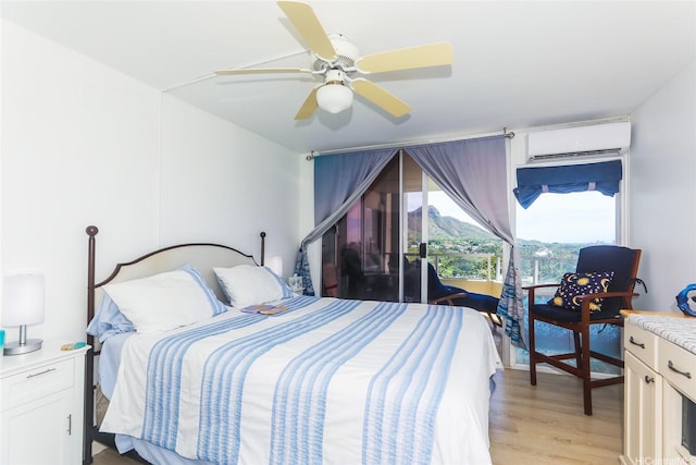 2600 Pualani Way Unit 1201, Honolulu, HI 96815 - bedroom with light wood-type flooring, an AC wall unit, and ceiling fan