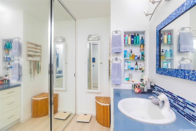 2600 Pualani Way Unit 1201, Honolulu, HI 96815 - bathroom with tasteful backsplash, wood finished floors, and a sink