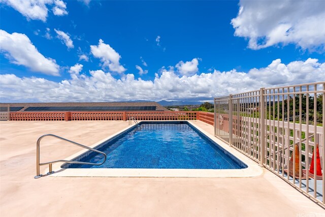 view of swimming pool featuring fence, a patio area, and a fenced in pool
