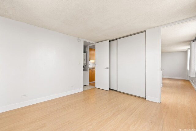 interior space featuring baseboards and light wood finished floors