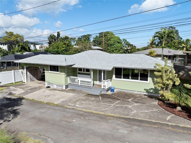 45-533 Pahia Rd, Kaneohe, HI 96744 - ranch-style house with covered porch, fence, concrete driveway, an attached garage, and a shingled roof