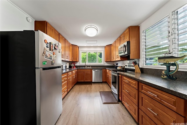 45-533 Pahia Rd, Kaneohe, HI 96744 - kitchen with stainless steel appliances, dark countertops, a sink, and light wood-style flooring