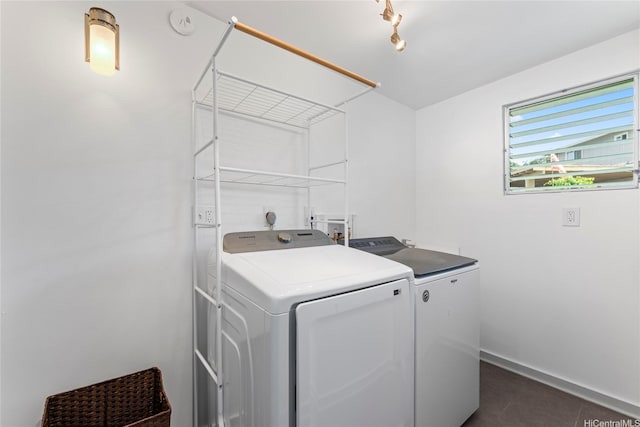 45-533 Pahia Rd, Kaneohe, HI 96744 - clothes washing area featuring dark tile patterned floors, baseboards, laundry area, and washer and dryer