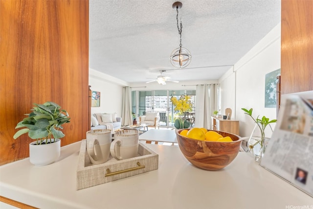 1615 Wilder Ave Unit 604, Honolulu, HI 96822 - dining area featuring a textured ceiling, ceiling fan, and a chandelier