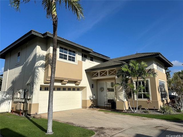 91-1005 Maulihiwa St, Kapolei, HI 96707 - view of front of home with an attached garage, stucco siding, concrete driveway, and a tiled roof