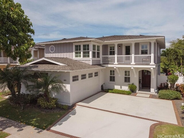 91-1068 Kaikohola St, Ewa Beach, HI 96706 - view of front of property featuring a balcony, concrete driveway, a shingled roof, a porch, and stucco siding