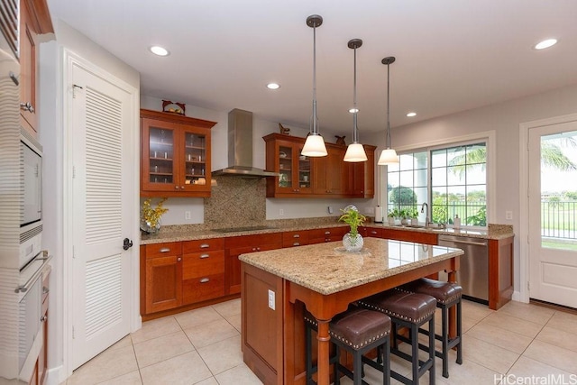 91-1068 Kaikohola St, Ewa Beach, HI 96706 - kitchen featuring wall chimney exhaust hood, dishwasher, brown cabinets, and light tile patterned floors